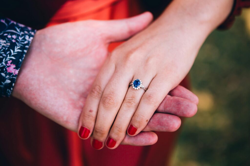 blue sapphire engagement ring worn by a woman