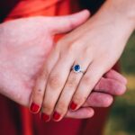 blue sapphire engagement ring worn by a woman